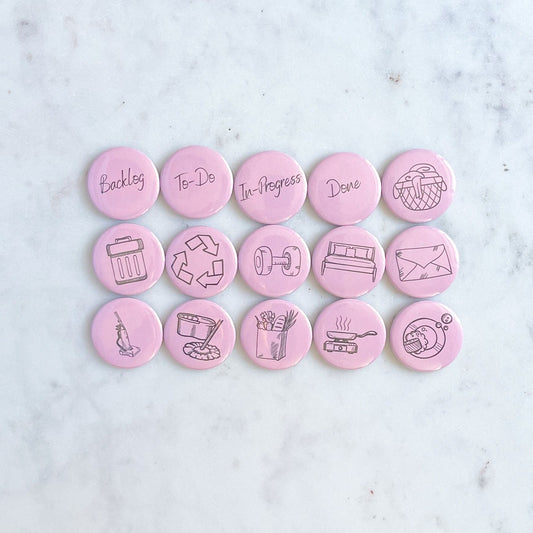 Set of 15 magnets with images representing different chores on a pink background. The magnets or on a marble table or surface